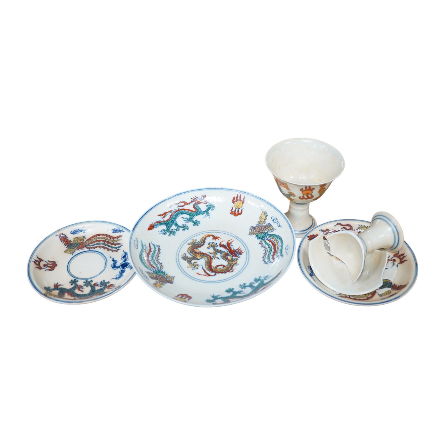 A pair of Chinese pedestal cups and three saucers. Condition - one cup severely damaged